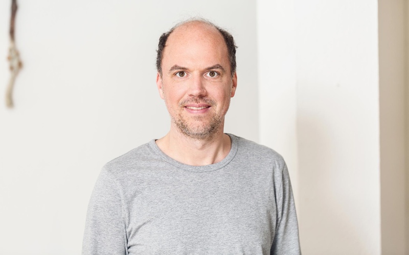 Portrait of a person in front of a white background.
